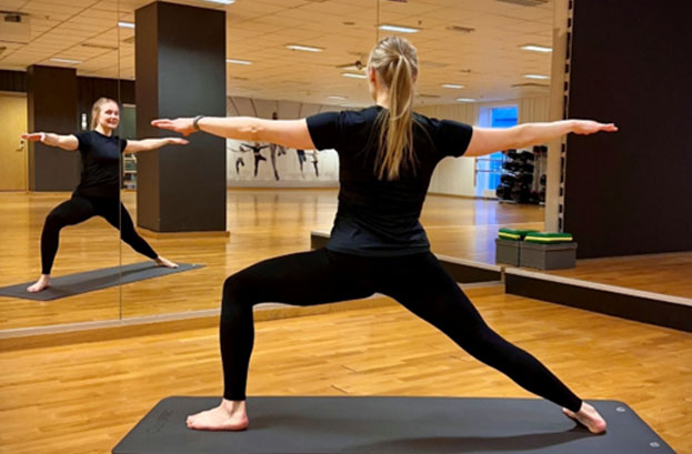 woman doing stretching exercise in a gym